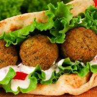 Falafel Pita · Perfect pita filled with falafel, juicy tomatoes, onions, cucumbers and tahini sauce. Served...