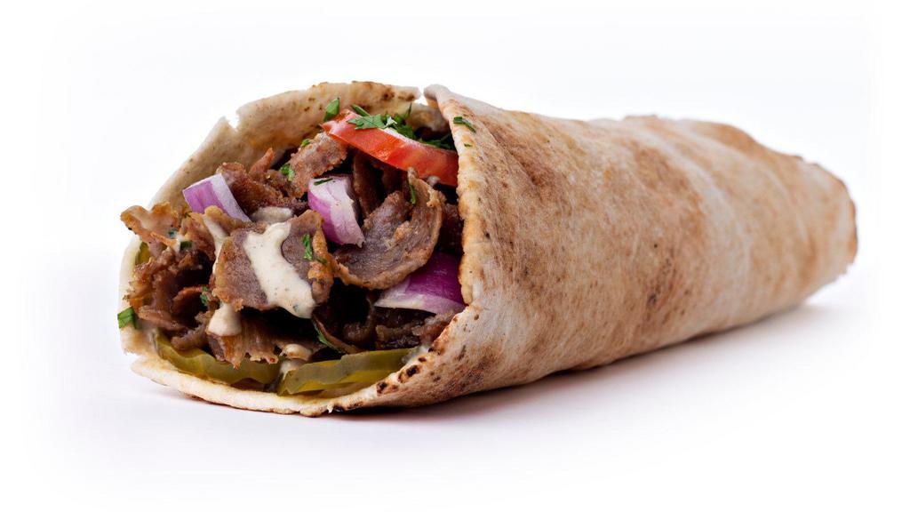 Beef Shawarma Pita · Mouthwatering beef shawarma made artfully in a pita with lettuce, tomatoes, onions, cucumbers and tahini sauce.