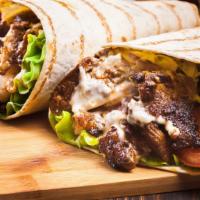 Arabic Beef Shawarma Wrap · Delicious Beef Shawarma Wrap with hot sauce and tahini sauce. Comes with a side of salad, fr...