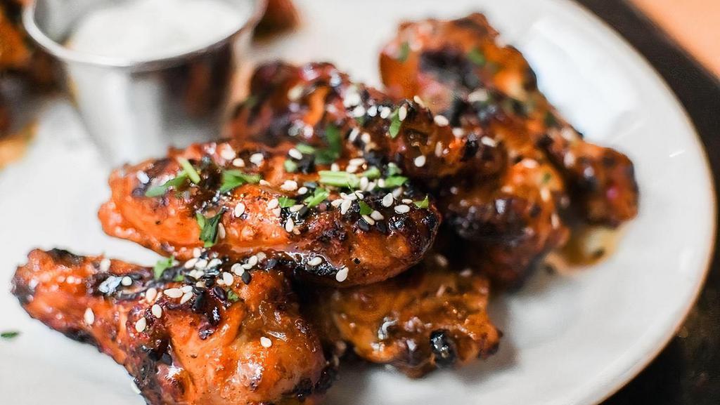 Wings · buttermilk marinated, grilled bone-in wings, herbs, garlic, asian buffalo sauce, sesame seeds, house-made restaurant ranch