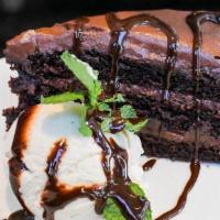 Chocolate Cake · House made cake and frosting.  Served with vanilla ice cream