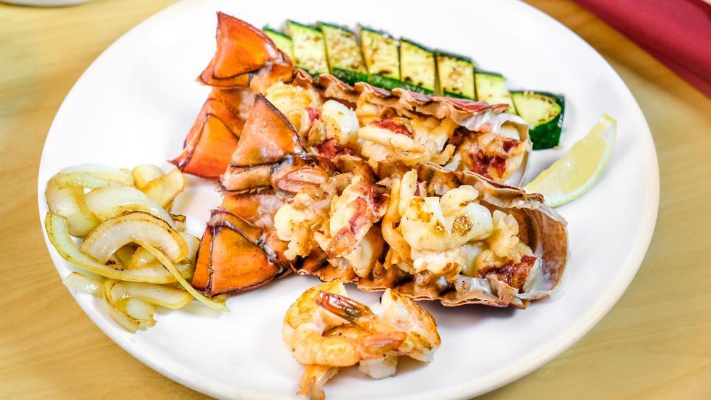 Twin Lobster Tails · Two cold water lobster tails grilled with butter and lemon.