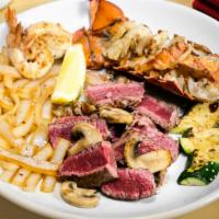 Deluxe Treat · Filet mignon and cold water lobster tail grilled with butter and lemon.