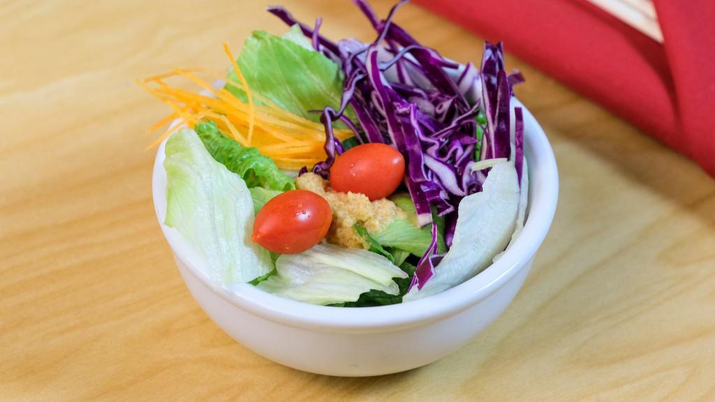 Benihana Salad · Crisp greens, red cabbage, carrots, and grape tomatoes in a homemade tangy ginger dressing.
