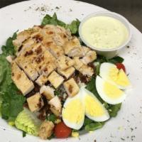 Joe'S Cobb Salad · Crisp romaine topped with grilled chicken, crumbled bleu cheese, bacon, tomatoes and hard-bo...