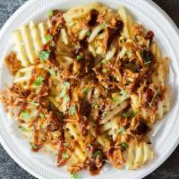 Southern Comfort Fries · Factory Fries topped with marinated BBQ pulled pork, honey BBQ sauce, and cilantro.