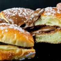 Nutella Brioche · A sweet brioche bun filled with nutella spread and topped with powdered sugar.