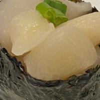 Scallop Nigiri · Scallop wrapped in nori on top of sushi rice.