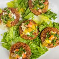 Loaded Falafel · Vegan, gluten free. House made falafel topped with creamy garlic sauce, tabouli and amba pur...