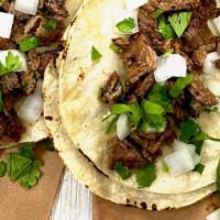 Carne Asada Taco · Double corn tortilla, grilled skirt steak, diced white onions, pulled cilantro, lime wedge &...