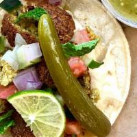 Vegan Falafel Taco · Double corn tortilla, Hummus spread, falafel ball, pico de Gallo, pickled cucumber, vegan Ta...