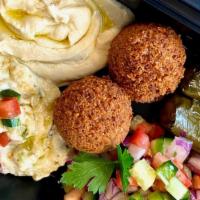 Mezze Platter · Hummus, Baba Ganough, Stuffed grape leaves, falafel, farmers salad & Pita Bread