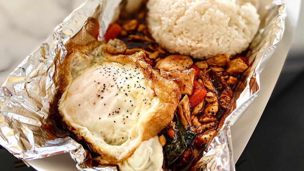 Thai Chicken Basil · Dairy-free. Chicken, diced red pepper, fresh basil with a fried egg, black pepper sprinkled on top and a side of white rice. Make it halal for an additional charge.