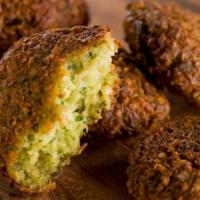 Falafel (6Pcs) · Fried ball like patties of Egyptian spiced ground chickpeas and fava beans.
