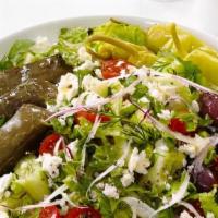 Stuffed Grape Leaves With Salad · Rice stuffed grape leaves served with your choice of Mediterranean salad