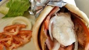 Gyro · Lamb and beef gyro sliced and served on a Greek pita with onions, tomatoes. Tzatziki sauce o...