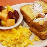French Toast Sandwich · Two thick slices of sweet egg bread, custard dipped, two eggs, choice of meat. Served with c...