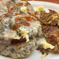 Southern Benedict · Focaccia biscuits, topped with country ham, scrambled eggs and finished with sausage gravy.