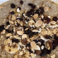 Kathy’S Oats · Hot, steel-cut oatmeal topped with almonds, craisins, bananas, and honey. Served with brown ...