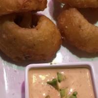 Onion Rings · Beer battered jumbo onion rings served with a spicy avocado ranch sauce.