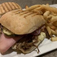 Cubano · A perfect combination of slow roasted pork shoulder, smoked ham, swiss cheese, crunchy pickl...