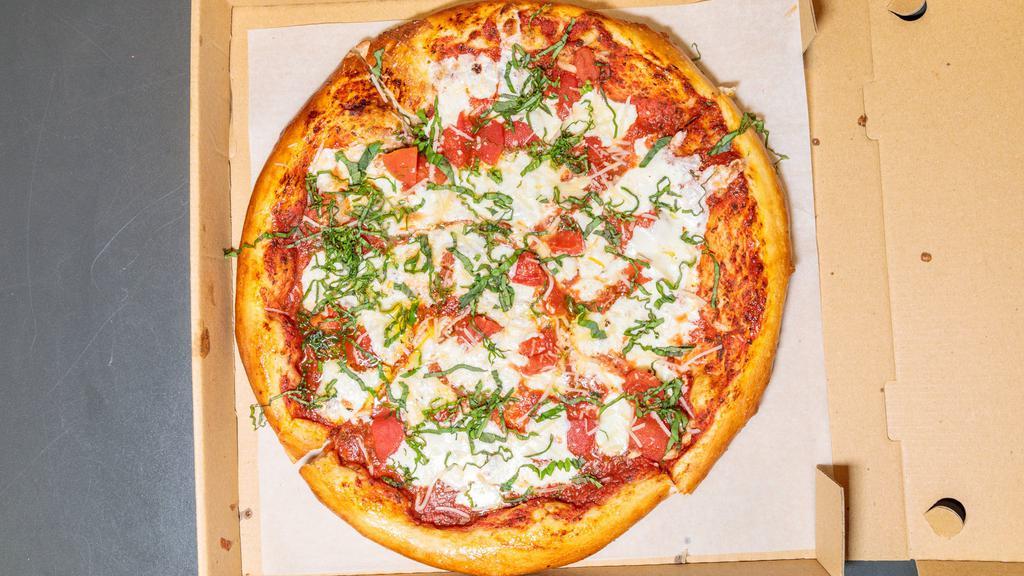 Margherita Pizza · Fresh diced tomato, grated mozzarella cheese, topped with finely cut basil.