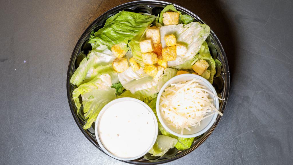 Caesar Salad · Freshly chopped romaine lettuce parmesan cheese croutons and caesar dressing.