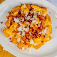 Drifter Tots · Tots smothered in Nacho Cheese, chopped Bacon & Raw Onion
