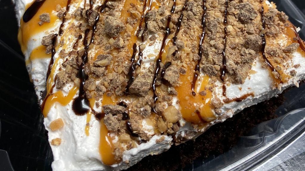 Better Than Sex Cake Slice · Chocolate  Cake with caramel drizzled in the inside. Topped with Whipped Frosting, Chocolate and Caramel Drizzle and Toffee Candy