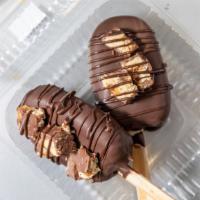 Snicker Cake Pop · 2 Chocolate cakesicles.  Dipped in Chocolate Drizzled with Caramel . Topped with Snicker Can...