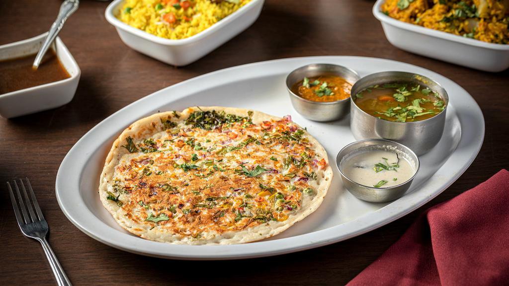 Utta Pam · Vegan and gluten-free. Lentil & Rice Pancake with Sambar and Coconut Chutney.
Topped with fresh garden vegetables: Cilantro, Onion, Bell
Pepper, Carrot, Tomato, Green Peas, Thai Chili Pepper.