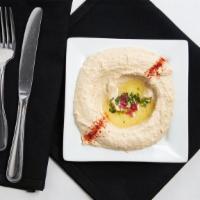 Hummus · Chickpeas blended with lemon juice, garlic and tahini sauce topped with olive oil and fresh ...