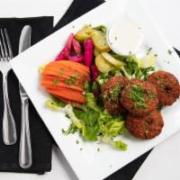 Falafel · Fried patties of chickpeas, parsley, onions, and herbs served with tomatoes, turnips, and ta...