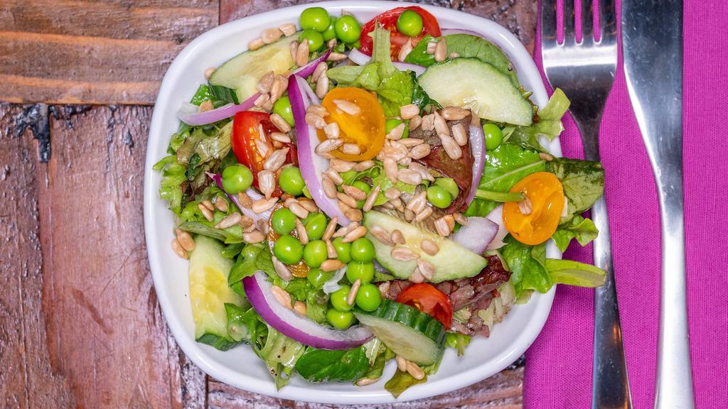 House Salad · Organic greens, cucumber, onion, peas, tomato, sunflower seeds, champagne vinaigrette.