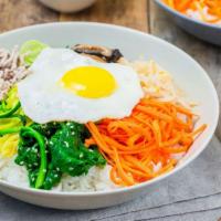 Bibimbap · Rice topped with beef, vegetables and spicy sauce.