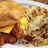 Bacon Or Ham, Scrambled Egg & American Cheese Croissant With Hash Browns · 