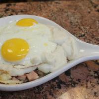 Hungryman Skillet · With hash browns, ham, bacon, sausage, onions, green peppers, country gravy and two eggs on ...