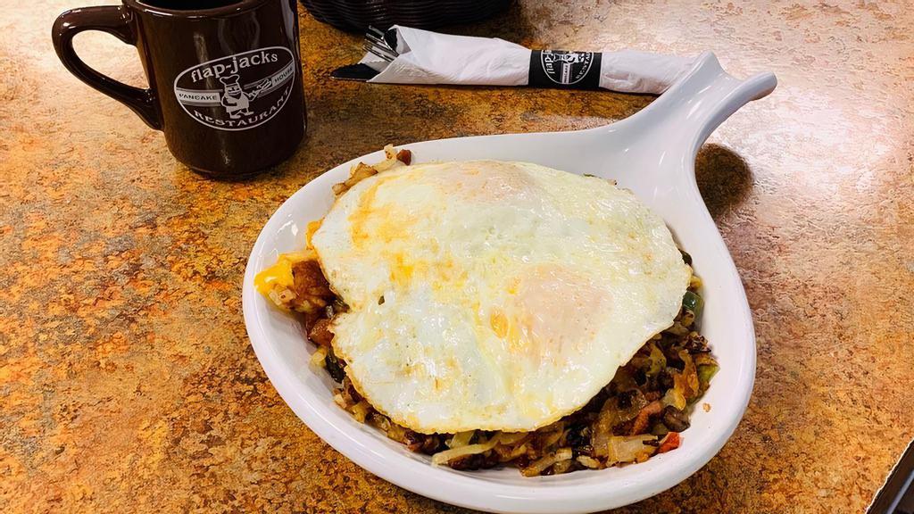 Mexican Skillet · With hash browns, chorizo sausage, onions, green peppers, tomatoes, jalapeños, pepper jack cheese and two eggs on top. Served with side of salsa & sour cream.