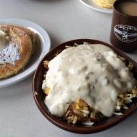 Country Scrambler · Hash browns scrambled into two eggs.  Topped with country gravy.