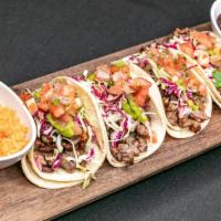 Tacos · Four delicious street tacos with rice and beans on the side. Select up to 2 varieties per or...
