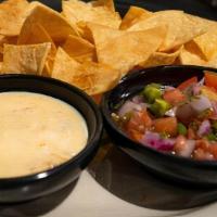 Chip Dip Trio · HTaco chips with queso, pico tomato salsa and black bean corn salsa on the side.