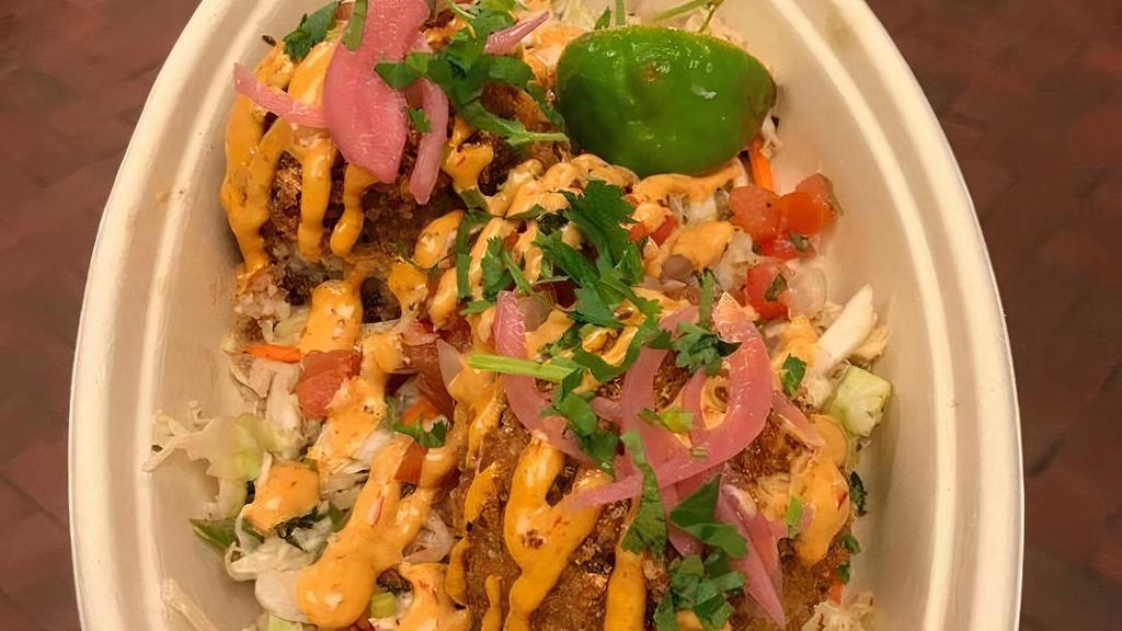 Crispy Rice App · Two balls of Crispy Fried Rice on slaw with pico tomato salsa, pickled red onion, chipotle aioli and cilantro mix.