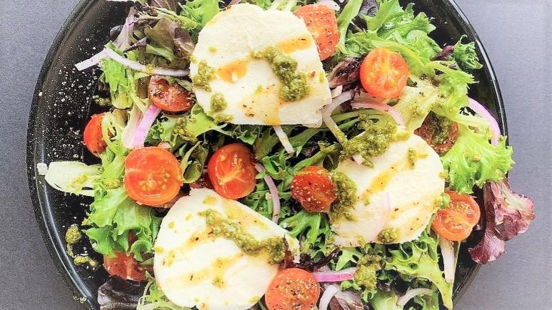 Caprese Salad · This salad comes packed with local love! Bed of local greens, cherry tomatoes, onions, and Snowville Creamery fresh mozzarella, topped with pesto and housemade balsamic vinaigrette.