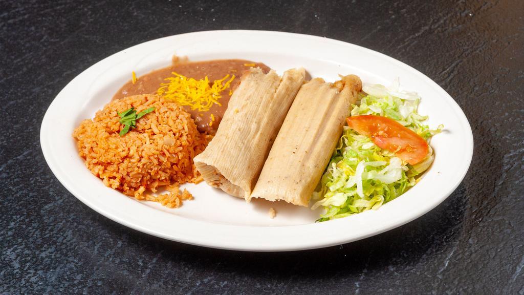 Fresh Handmade Tamales · Two tamales, made with fresh stone-ground corn masa, filled with Felipe's pork mole, wrapped in corn husks and steamed. Served with beans & rice.