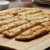 Cheesy Garlic Bread · These breadsticks have our signature garlic spread and fresh diced mozzarella cheese