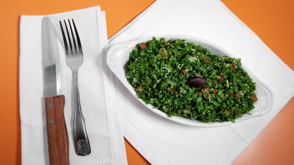 Large Tabbouli · Mixture of chopped parsley, tomatoes, onions, cracked wheat, tossed with our olive oil blend and lemon juice.