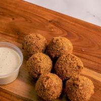 Falafel · Vegan and gluten free. Six pieces. Fresh ground chickpeas, parsley, onions, and special spic...