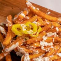Greek Fries · Seasoned straight cut french fries with banana peppers, feta cheese and tzatziki sauce on top