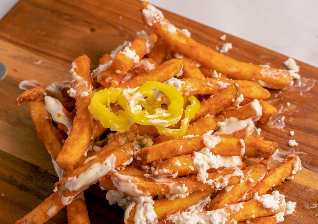 Greek Fries · Seasoned straight cut french fries with banana peppers, feta cheese and tzatziki sauce on top