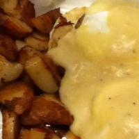 Country Benedict · Sausage and poached eggs over grilled English muffins and covered with homemade andouille gr...